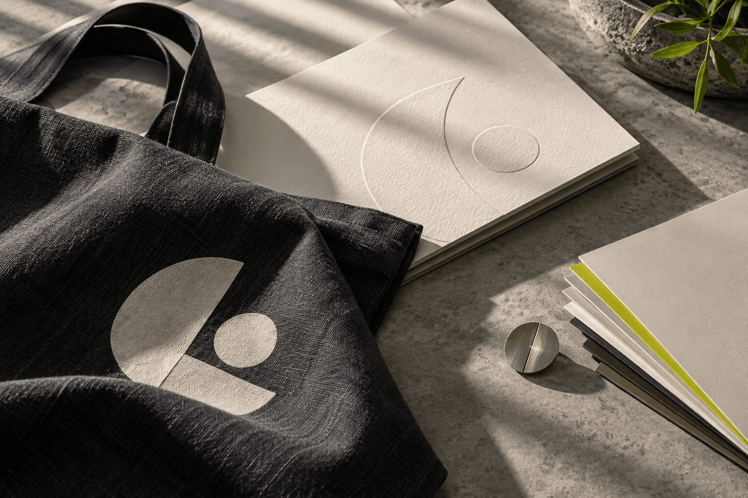 Branded tote bag, notebook and paper set on stone